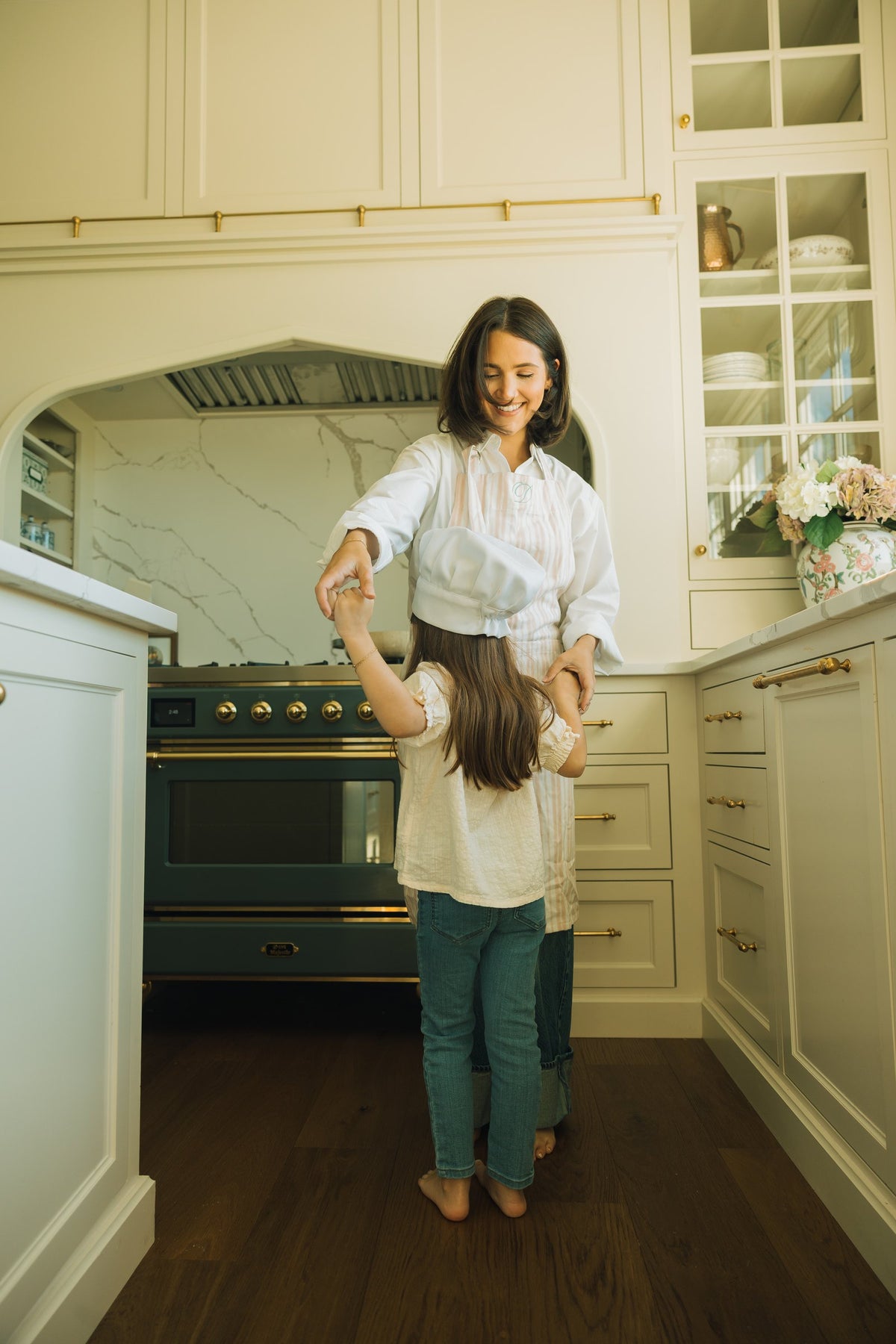 A mother and daughter dancing in the Sweet Logic kitchen